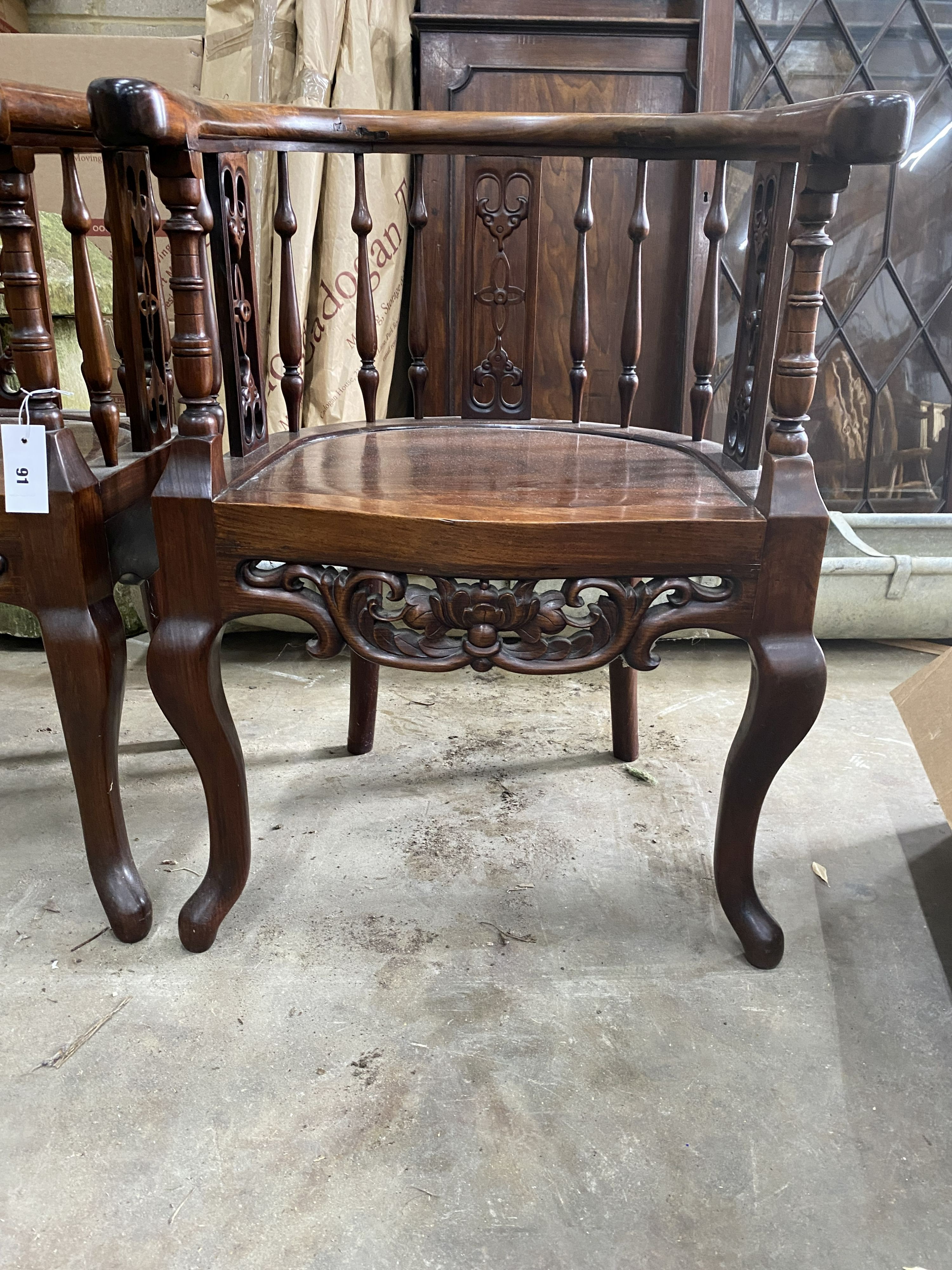 A pair of Chinese carved hardwood elbow chairs, width 55cm, depth 50cm, height 79cm